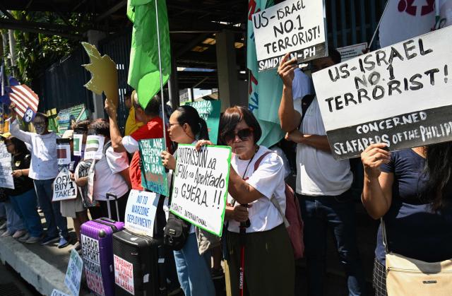 Activists demonstrate in front of the Department of Migrant Workers (DMW) headquarters in Manila on March 30, 2026, as they call for the protection of Philippine migrant workers in the Middle East after US-Israeli strikes on Iran last month triggered a war in the region. (Photo by Ted ALJIBE / AFP)