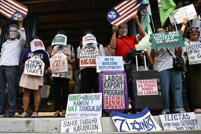 Activists demonstrate in front of the Department of Migrant Workers (DMW) headquarters in Manila on March 30, 2026, as they call for the protection of Philippine migrant workers in the Middle East after US-Israeli strikes on Iran last month triggered a war in the region. (Photo by Ted ALJIBE / AFP)