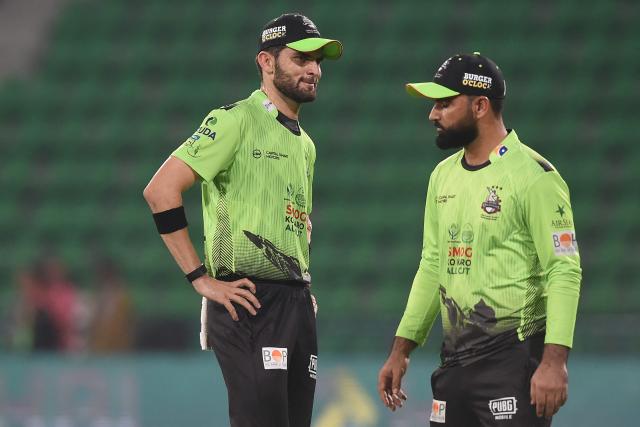 Lahore Qalandars' captain Shaheen Shah Afridi (L) speaks with teammate Fakhar Zaman (R) during the Pakistan Super League (PSL) T20 match between Karachi Kings and Lahore Qalandars at the Gaddafi Cricket Stadium in Lahore on March 29, 2026. Lahore Qalandars' Fakhar Zaman could face a ban after being charged with a ball-tampering offence in his side's defeat to Karachi Kings in the T20 Pakistan Super League. (Photo by Syed Murtaza Ali / AFP)