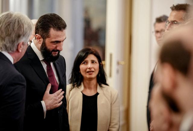 Syrian President Ahmed al-Sharaa (2L) is welcomed at the Bellevue presidential palace in Berlin on March 30, 2026. Syria's President Ahmed al-Sharaa visits Germany on Monday for talks on the Middle East war, rebuilding his country and Berlin's efforts to send back Syrian refugees. (Photo by Kay Nietfeld / dpa / AFP)