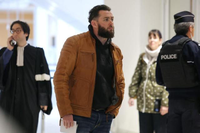 Defendant Jeremy Ferretti arrives for  the opening of the so-called Athanor trial, in which 22 people are facing a wide range of charges, including murder, centred on the Athanor Masonic lodge accused of running hit squads, at the Assize Court in the Tribunal Judiciaire courthouse in Paris, on March 30, 2026. The 22 defendants are accused of murder, attempted murder, aggravated assault and criminal conspiracy on behalf of a mafia network inside the Athanor Masonic Lodge in the Paris suburb of Puteaux. At least four freemasons from the 20 or so members of the lodge are in the dock. Other defendants include four officers from France's DGSE foreign intelligence service, three police officers, six business executives, a security guard, a doctor and an engineer. (Photo by Thomas SAMSON / AFP)