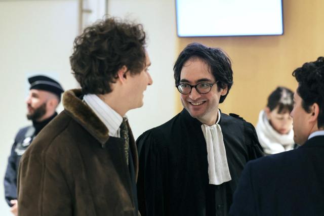 Dylan Slama (R), lawyer of unionist Hassan Touzani, speaks with Antoine Ory (L), lawyer of defendant Sebastien Leroy, as they arrive for the opening of the so-called Athanor trial, in which 22 people are facing a wide range of charges, including murder, centred on the Athanor Masonic lodge accused of running hit squads, at the Assize Court in the Tribunal Judiciaire courthouse in Paris, on March 30, 2026. The 22 defendants are accused of murder, attempted murder, aggravated assault and criminal conspiracy on behalf of a mafia network inside the Athanor Masonic Lodge in the Paris suburb of Puteaux. At least four freemasons from the 20 or so members of the lodge are in the dock. Other defendants include four officers from France's DGSE foreign intelligence service, three police officers, six business executives, a security guard, a doctor and an engineer. (Photo by Thomas SAMSON / AFP)