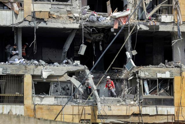 First-responders search a heavily-damaged building that was hit by an Israeli airstrike in Beirut’s southern suburbs on March 30, 2026. A strike hit Beirut's southern suburbs on March 30 after Israel issued a warning for people in the Hezbollah stronghold to leave. The strike is the first since March 27 in the area, which is now largely deserted since Israel began frequent attacks against Hezbollah earlier in the month. (Photo by Anwar AMRO / AFP) / 