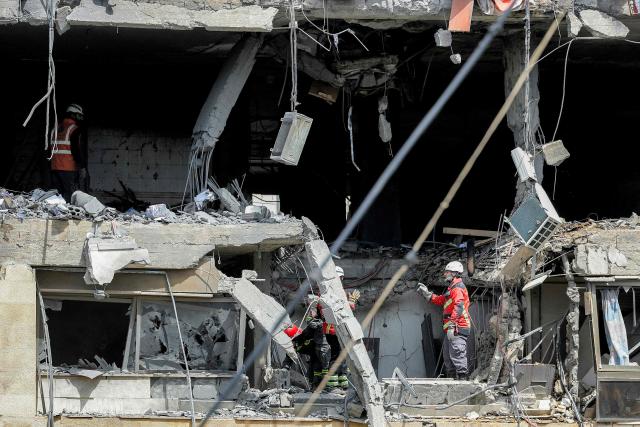First-responders search a heavily-damaged building that was hit by an Israeli airstrike in Beirut’s southern suburbs on March 30, 2026. A strike hit Beirut's southern suburbs on March 30 after Israel issued a warning for people in the Hezbollah stronghold to leave. The strike is the first since March 27 in the area, which is now largely deserted since Israel began frequent attacks against Hezbollah earlier in the month. (Photo by Anwar AMRO / AFP) / 