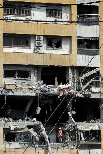 First-responders search a heavily-damaged building that was hit by an Israeli airstrike in Beirut’s southern suburbs on March 30, 2026. A strike hit Beirut's southern suburbs on March 30 after Israel issued a warning for people in the Hezbollah stronghold to leave. The strike is the first since March 27 in the area, which is now largely deserted since Israel began frequent attacks against Hezbollah earlier in the month. (Photo by Anwar AMRO / AFP) / 