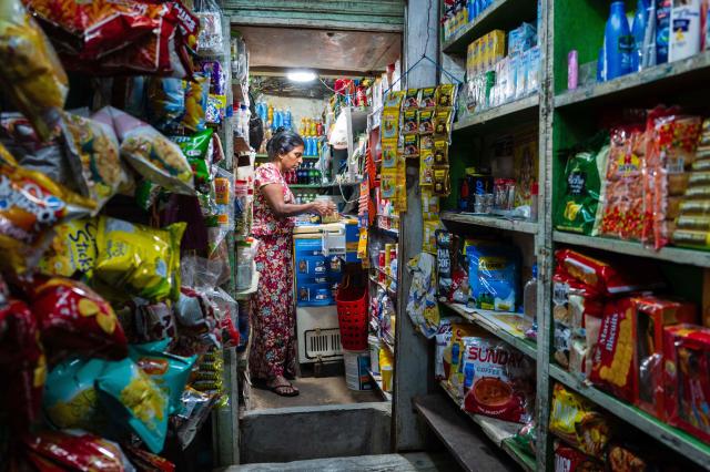 A shopkeeper waits for customers in Yangon on March 29, 2026. (Photo by ANTHONY WALLACE / AFP)