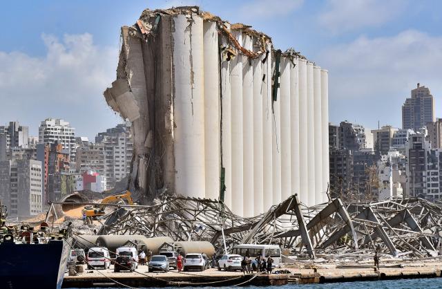 (FILES) The grain silo in the port of Beirut stands damaged four days after a monster explosion killed more than 150 people and disfigured the Lebanese capital, on August 8, 2020. Lebanese judge Tarek Bitar has completed his investigation into the 2020 Beirut port blast, a years-long case that involves possible charges against dozens of people, a judicial official told AFP on March 30, 2026. Since 2023, the investigation into the massive Beirut port explosion, which killed more than 220 people on August 4, 2020, has been in jeopardy after Hezbollah led a campaign demanding the removal of Bitar, who was later hit with dozens of lawsuits to remove him from the case. (Photo by AFP)