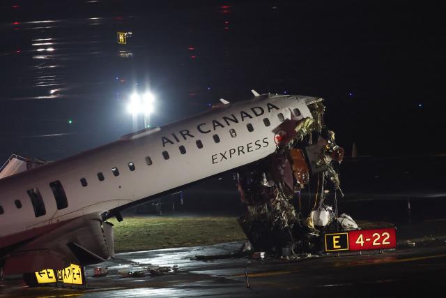 (FILES) An Air Canada Express CRJ-900 sits on the runway after colliding with a Port Authority fire truck at LaGuardia Airport in New York, on March 23, 2026. Air Canada said on March 30, 2026, that its CEO Michael Rousseau will retire later this year, in an announcement following controversy over his failure to issue condolences for a fatal airport disaster both in English and French. Rousseau has informed the company's board that he "will retire by the end of the third quarter" this year after nearly two decades of leadership, the firm said. (Photo by ANGELA WEISS / AFP)