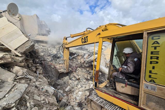 First responders work on the rubble of a building targeted by an Israeli airstrike in the southern Lebanese village of Hanouiyeh, east of Tyre, on March 30, 2026. Israel renewed its bombardment of Beirut's southern suburbs on March 30 while continuing air strikes on Lebanon's south, one of which targeted an army checkpoint and killed a soldier. Lebanon was pulled into the Middle East conflict when Tehran-backed armed group Hezbollah fired rockets at Israel on March 2 in revenge for the killing of Iran's supreme leader, the opening salvo in the US-Israeli war against the Islamic republic. (Photo by KAWNAT HAJU / AFP)