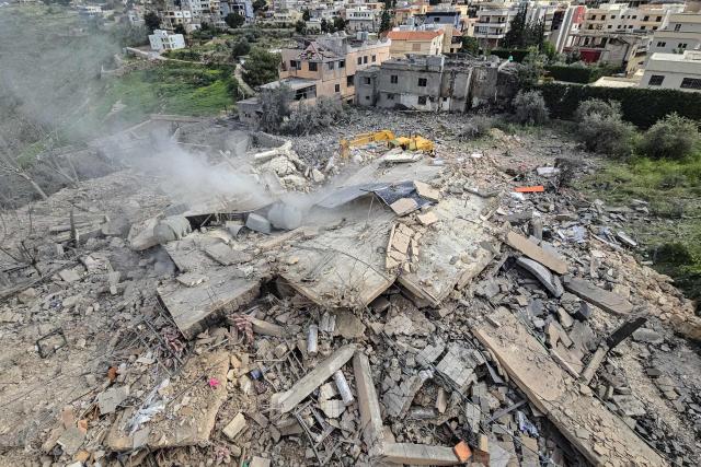 First responders work on the rubble of a building targeted by an Israeli airstrike in the southern Lebanese village of Hanouiyeh, east of Tyre, on March 30, 2026. Israel renewed its bombardment of Beirut's southern suburbs on March 30 while continuing air strikes on Lebanon's south, one of which targeted an army checkpoint and killed a soldier. Lebanon was pulled into the Middle East conflict when Tehran-backed armed group Hezbollah fired rockets at Israel on March 2 in revenge for the killing of Iran's supreme leader, the opening salvo in the US-Israeli war against the Islamic republic. (Photo by KAWNAT HAJU / AFP)