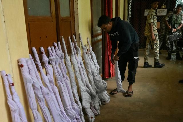 A security officer carries recovered seized arms taken from killed Maoist insurgents to display at a police facility in Dantewada district of Chhattisgarh’s Bastar division on March 30, 2026. India on March 30 declared the country free of the Maoist insurgency, fulfilling a long-standing deadline to defeat the decades-long rebellion. Home Minister Amit Shah told parliament that India was "free" of the rebels, known as Naxals. (Photo by Shammi MEHRA / AFP)