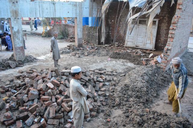 A resident clears mud from a house after its roof collapsed following heavy rain and a storm in Bannu, Pakistan’s Khyber Pakhtunkhwa province on March 30, 2026. Heavy rain and storms have killed at least 45 people over the past few days across Afghanistan and Pakistan, disaster officials in both countries said on March 30. (Photo by Karim ULLAH / AFP)