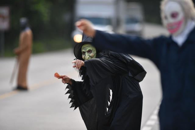 Fancy-dressed parishioners walk through the streets asking for money as part of the Holy Week folk tradition, in Santa Barbara, about 200 kilometers northwest of Tegucigalpa, on March 30, 2026. (Photo by Orlando SIERRA / AFP)