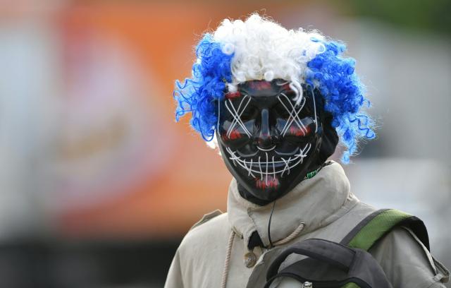 A fancy-dressed parishioner walks through the streets asking for money as part of the Holy Week folk tradition, in Santa Barbara, about 200 kilometers northwest of Tegucigalpa, on March 30, 2026. (Photo by Orlando SIERRA / AFP)