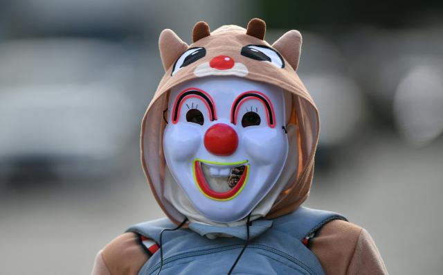 A fancy-dressed parishioner walks through the streets asking for money as part of the Holy Week folk tradition, in Santa Barbara, about 200 kilometers northwest of Tegucigalpa, on March 30, 2026. (Photo by Orlando SIERRA / AFP)