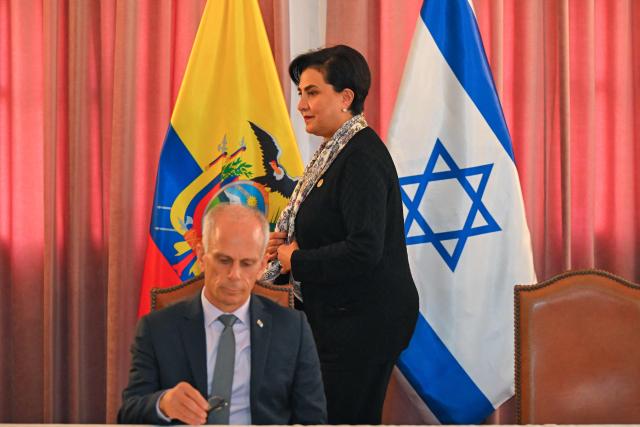 Ecuador’s Foreign Minister Gabriela Sommerfeld walks next to Israel’s Ambassador to Ecuador, Tzach Sarid, during the signing of bilateral agreements in the areas of culture and sports at the Foreign Ministry in Quito on March 30, 2026. (Photo by Rodrigo BUENDIA / AFP)