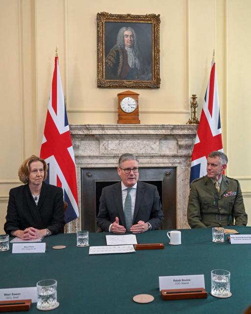 Britain's Prime Minister Keir Starmer (C) sits, flanked by BP CEO appointee Meg O'Neill (L) and Major General Richard Cantrill, Commander Operations (Royal Navy) (R), at a meeting to discuss the US-Israeli conflict with Iran and the impact on the Strait of Hormuz, inside 10 Downing Street in London on March 30, 2026. British Prime Minister Keir Starmer convenes with major players in the economic world, including those from the energy sector, and government officials to discuss the consequences of the war in Iran. (Photo by Jaimi Joy / POOL / AFP)