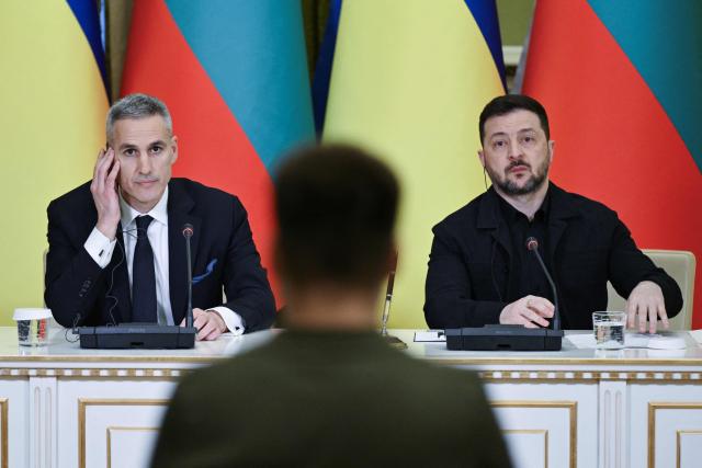 Ukrainian President Volodymyr Zelensky (R) and Bulgarian Prime Minister Andrey Gyurov (L) listen to a journalist's question during a joint press conference after meeting in Kyiv on March 30, 2026, amid the Russian invasion of Ukraine. (Photo by Genya SAVILOV / AFP)