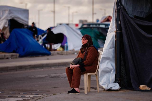 An elderly displaced woman sits in front of her tent along Beiruts seafront area on March 30, 2026. Israel renewed its bombardment of Beirut's southern suburbs on March 30 while continuing air strikes on Lebanon's south, one of which targeted an army checkpoint and killed a soldier. Lebanon was pulled into the Middle East conflict when Tehran-backed armed group Hezbollah fired rockets at Israel on March 2 in revenge for the killing of Iran's supreme leader, the opening salvo in the US-Israeli war against the Islamic republic. (Photo by Dimitar DILKOFF / AFP)