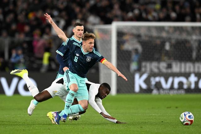 (From L) Germany's midfielder #05 Pascal Gross, Germany's defender #06 Joshua Kimmich and Ghana's midfielder #05 Thomas Partey vie for the ball during the international friendly football match between Germany and Ghana in Stuttgart, southwestern Germany on March 30, 2026. (Photo by THOMAS KIENZLE / AFP)