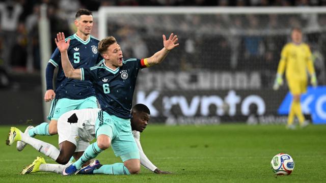Germany's midfielder #05 Pascal Gross (L), Germany's defender #06 Joshua Kimmich (C) and Ghana's midfielder #05 Thomas Partey vie for the ball during the international friendly football match between Germany and Ghana in Stuttgart, southwestern Germany on March 30, 2026. (Photo by THOMAS KIENZLE / AFP)