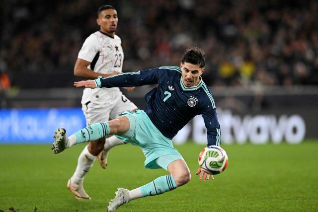 Germany's forward #07 Kai Havertz (front) and Ghana's forward #23 Alexander Djiku vie for the ball during the international friendly football match between Germany and Ghana in Stuttgart, southwestern Germany on March 30, 2026. (Photo by THOMAS KIENZLE / AFP)