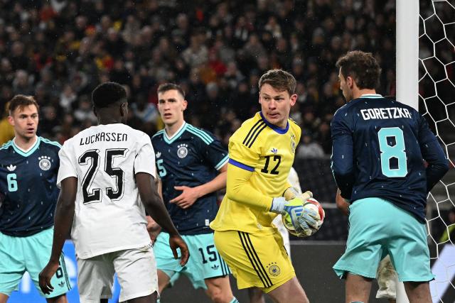 Germany's goalkeeper #12 Alexander Nuebel (2R) saves the ball during the international friendly football match between Germany and Ghana in Stuttgart, southwestern Germany on March 30, 2026. (Photo by THOMAS KIENZLE / AFP)