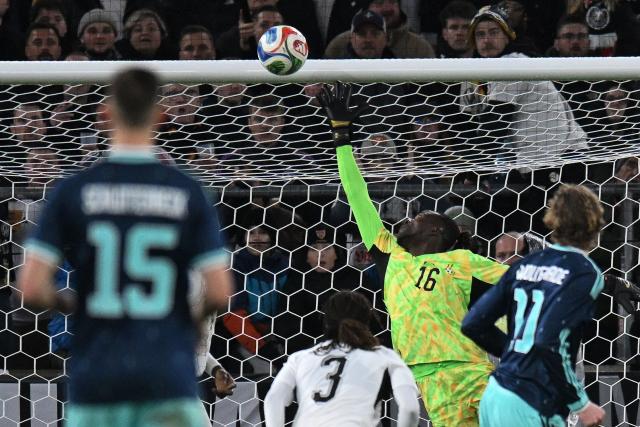 Ghana's goalkeeper #16 Benjamin Asare (2R) saves the ball from Germany's forward #11 Nick Woltemade (R) during the international friendly football match between Germany and Ghana in Stuttgart, southwestern Germany on March 30, 2026. (Photo by THOMAS KIENZLE / AFP)