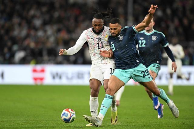 Ghana's forward #11 Antoine Semenyo (L) and Germany's defender #23 Josha Vagnoman vie for the ball during the international friendly football match between Germany and Ghana in Stuttgart, southwestern Germany on March 30, 2026. (Photo by THOMAS KIENZLE / AFP)