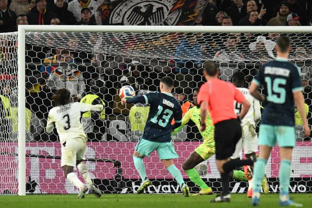 TOPSHOT - Germany's forward #13 Deniz Undav (2L) scores his team's second goal during the international friendly football match between Germany and Ghana in Stuttgart, southwestern Germany on March 30, 2026. (Photo by THOMAS KIENZLE / AFP)