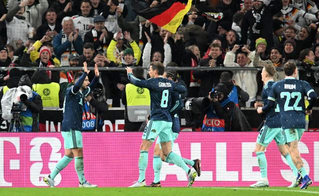 Germany's forward #13 Deniz Undav (L) celebrates scoring his team's second goal with teammates during the international friendly football match between Germany and Ghana in Stuttgart, southwestern Germany on March 30, 2026. Germany won the match 2-1. (Photo by THOMAS KIENZLE / AFP)