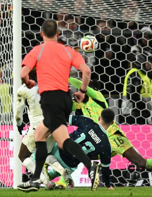 Germany's forward #13 Deniz Undav (2R) scores his team's second goal against Ghana's goalkeeper #16 Benjamin Asare (R) during the international friendly football match between Germany and Ghana in Stuttgart, southwestern Germany on March 30, 2026. (Photo by THOMAS KIENZLE / AFP)