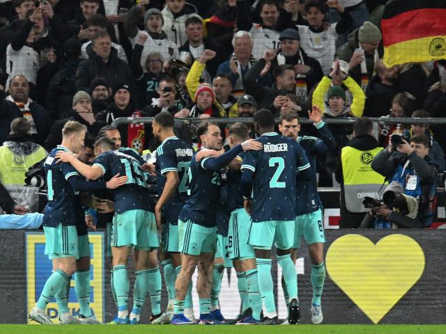 Germany's players celebrate forward #13 Deniz Undav after he scored his team's second goal during the international friendly football match between Germany and Ghana in Stuttgart, southwestern Germany on March 30, 2026. Germany won the match 2-1. (Photo by THOMAS KIENZLE / AFP)