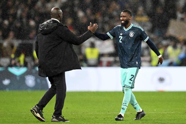 Germany's defender #02 Antonio Ruediger (R) greets Ghana's head coach Otto Addo after the international friendly football match between Germany and Ghana in Stuttgart, southwestern Germany on March 30, 2026. Germany won the match 2-1. (Photo by THOMAS KIENZLE / AFP)