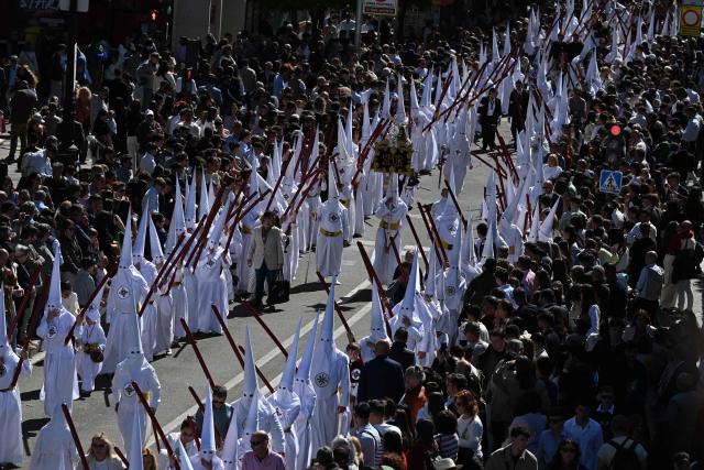 Penitents of the San Gonzalo brotherhood take part in the Holy Monday procession in Seville, Spain, on March 30, 2026. Christian believers around the world mark Holy Week in celebration of the crucifixion and resurrection of Jesus Christ. (Photo by CRISTINA QUICLER / AFP)