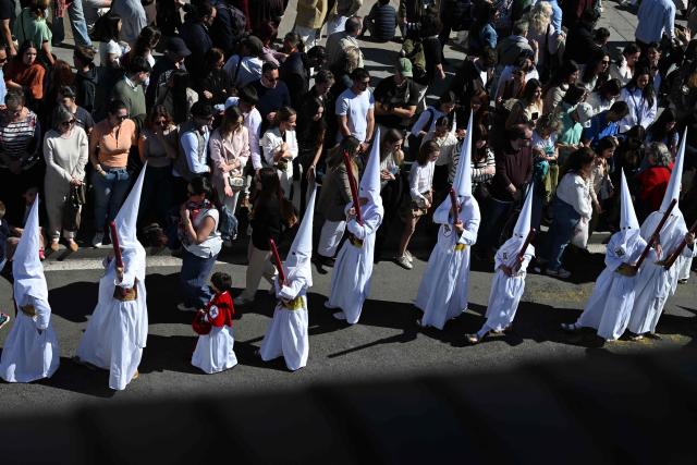Penitents of the San Gonzalo brotherhood take part in the Holy Monday procession in Seville, Spain, on March 30, 2026. Christian believers around the world mark Holy Week in celebration of the crucifixion and resurrection of Jesus Christ. (Photo by CRISTINA QUICLER / AFP)