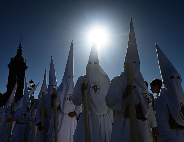 TOPSHOT - Penitents of the San Gonzalo brotherhood take part in the Holy Monday procession in Seville, Spain, on March 30, 2026. Christian believers around the world mark Holy Week in celebration of the crucifixion and resurrection of Jesus Christ. (Photo by CRISTINA QUICLER / AFP)