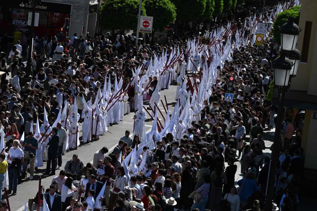 Penitents of the San Gonzalo brotherhood take part in the Holy Monday procession in Seville, Spain, on March 30, 2026. Christian believers around the world mark Holy Week in celebration of the crucifixion and resurrection of Jesus Christ. (Photo by CRISTINA QUICLER / AFP)