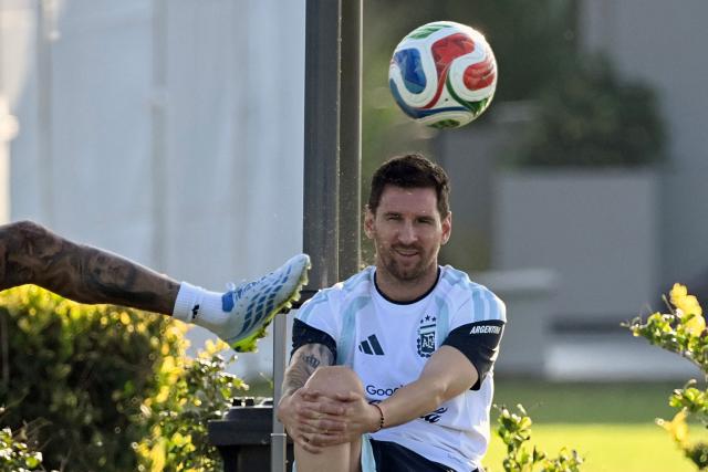 Argentina's midfielder Rodrigo De Paul (out of frame) kicks the ball as teammate forward Lionel Messi looks on during a training session in Ezeiza, Buenos Aires province, Argentina on March 30, 2026, ahead of a friendly match against Zambia on March 31 at the La Bombonera Stadium in Buenos Aires. (Photo by Luis ROBAYO / AFP)
