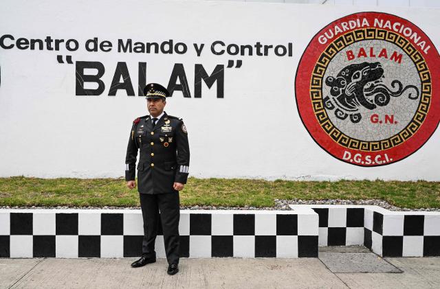 Colonel Rodolfo Blancas, Director of Planning and Supervision for Highways, Airports, Ports, and Borders of Mexico's National Guard, poses for a picture after an interview with AFP at the National Guard headquarters in the Iztapalapa district of Mexico City on March 30, 2022. Cargo transport robbery in Mexico has decreased in recent months, which authorities attribute to measures they have implemented to prevent this crime, such as monitoring and escorting tractor?trailers. (Photo by Yuri CORTEZ / AFP)