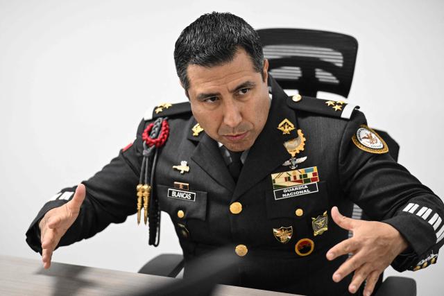 Colonel Rodolfo Blancas, Director of Planning and Supervision for Highways, Airports, Ports, and Borders of Mexico's National Guard, speaks during an interview with AFP at the National Guard headquarters in the Iztapalapa district of Mexico City on March 30, 2022. Cargo transport robbery in Mexico has decreased in recent months, which authorities attribute to measures they have implemented to prevent this crime, such as monitoring and escorting tractor?trailers. (Photo by Yuri CORTEZ / AFP)