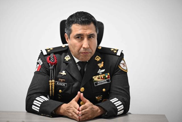 Colonel Rodolfo Blancas, Director of Planning and Supervision for Highways, Airports, Ports, and Borders of Mexico's National Guard, speaks during an interview with AFP at the National Guard headquarters in the Iztapalapa district of Mexico City on March 30, 2022. Cargo transport robbery in Mexico has decreased in recent months, which authorities attribute to measures they have implemented to prevent this crime, such as monitoring and escorting tractor?trailers. (Photo by Yuri CORTEZ / AFP)