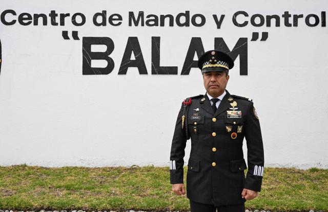 Colonel Rodolfo Blancas, Director of Planning and Supervision for Highways, Airports, Ports, and Borders of Mexico's National Guard, poses for a picture after an interview with AFP at the National Guard headquarters in the Iztapalapa district of Mexico City on March 30, 2022. Cargo transport robbery in Mexico has decreased in recent months, which authorities attribute to measures they have implemented to prevent this crime, such as monitoring and escorting tractor?trailers. (Photo by Yuri CORTEZ / AFP)