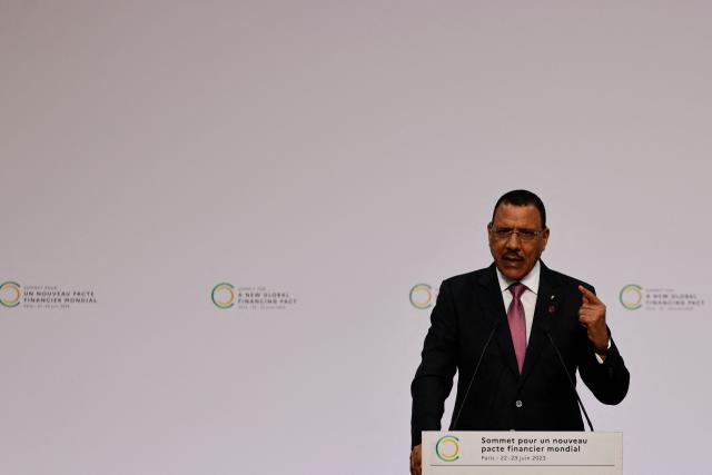 (FILES) President of Niger, Mohamed Bazoum delivers a speech during the opening session of the New Global Financial Pact Summit at the Palais Brongniart in Paris on June 22, 2023. The term of Nigerien President Mohamed Bazoum, overthrown in a coup on July 26, 2023, by a military junta that has held him ever since, ends on Thursday, with no immediate prospect of his release or a trial.
Mr. Bazoum was sworn in as president on April 2, 2021, after winning the presidential election with 55% of the vote. Since the coup that brought General Abdourahamane Tiani's junta to power, he has consistently refused to resign and remains detained with his wife in a wing of the presidential palace in the capital, Niamey.
But for his lawyers, this April 2 date is meaningless, as Mr. Bazoum has been unable to perform his duties since July 2023. "April 2 will not be the end of his term," Moussa Coulibaly, a member of Mohamed Bazoum's legal team, told AFP. (Photo by Ludovic MARIN / POOL / AFP)