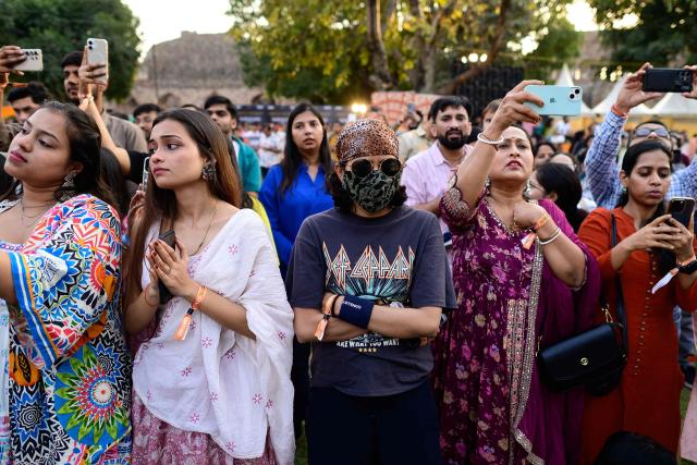 (FILES) Revellers enjoy Hindu spiritual songs called 'Bhajans' during the Sanatan Journey devotional music festival at the iconic Purana Qila in New Delhi on March 1, 2026. In India's capital, Hindu "bhajan clubbing" is electrifying nightlife, with revellers dancing to traditional devotional songs reimagined through guitars and pounding drumbeats, transforming public venues into spiritual hangouts. (Photo by Manan VATSYAYANA / AFP)