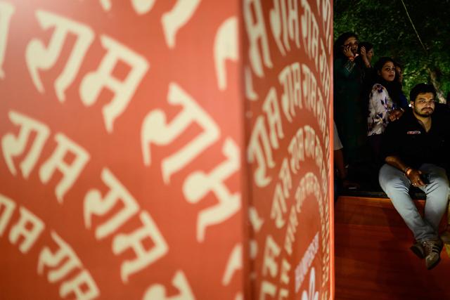 (FILES) Revellers enjoy Hindu spiritual songs called 'Bhajans' during the Sanatan Journey devotional music festival at the iconic Purana Qila in New Delhi on March 1, 2026. In India's capital, Hindu "bhajan clubbing" is electrifying nightlife, with revellers dancing to traditional devotional songs reimagined through guitars and pounding drumbeats, transforming public venues into spiritual hangouts. (Photo by Manan VATSYAYANA / AFP)