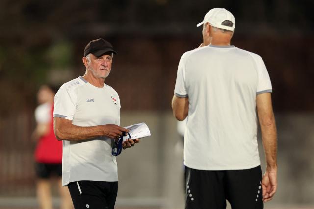 Iraq's Australian coach Graham Arnold talks with an assistant during a training session in Monterrey, Mexico on March 30, 2026, ahead of the FIFA World Cup qualifiers final playoff football match against Bolivia on March 31. (Photo by Julio Cesar AGUILAR / AFP)