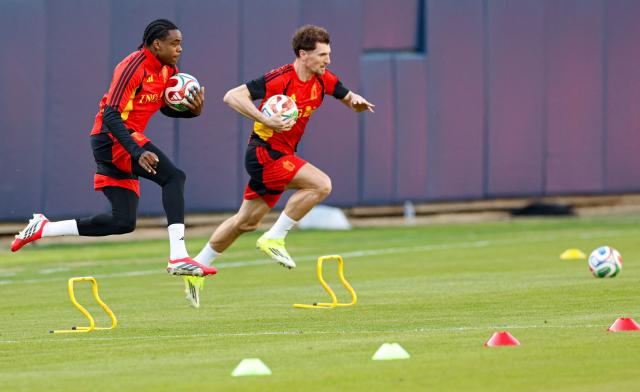 Belgium's defenders Nathan Ngoy (L) and Thomas Meunier (R) run with the ball during a training session at Soldier Field in Chicago, Illinois on March 30, 2026. Belgium is preparing for tomorrow's international friendly match against Mexico, in advance of the 2026 World Cup. (Photo by KAMIL KRZACZYNSKI / AFP)