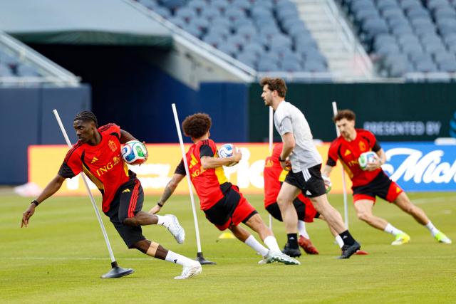 Belgium's midfielder Amadou Onana (L) runs with the ball during a training session at Soldier Field in Chicago, Illinois on March 30, 2026. Belgium is preparing for tomorrow's international friendly match against Mexico, in advance of the 2026 World Cup. (Photo by KAMIL KRZACZYNSKI / AFP)