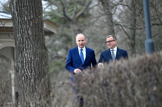 Finnish Prime Minister Petteri Orpo (R) and Irish Prime Minister Micheal Martin (L) speak together ahead of their meeting at the Prime Minister's official residence Kesaranta in Helsinki on March 31, 2026. (Photo by Emmi Korhonen / Lehtikuva / AFP) / Finland OUT